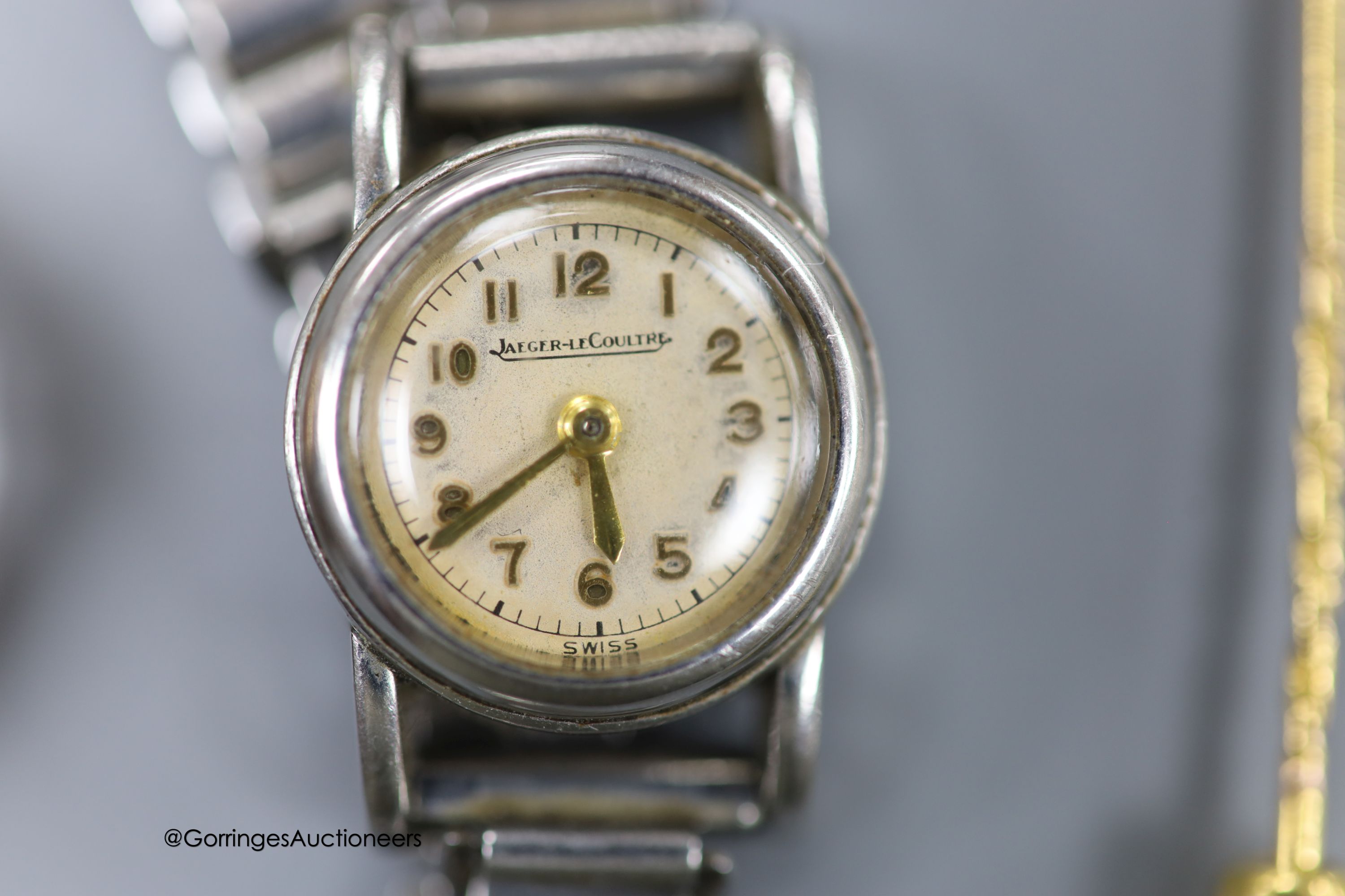 A 9ct gold signet ring, size S, 4.1 grams, a yellow metal and diamond set stick pin and a lady's stainless steel Jaeger LeCoultre back wind wrist watch, on steel bracelet.